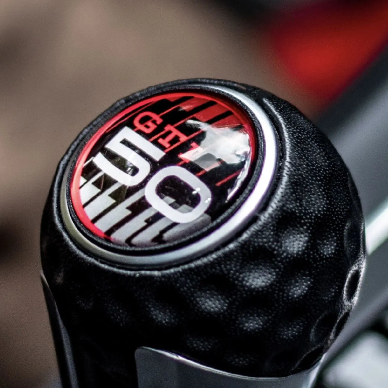 VW Golf gear knob with GTI 50th Anniversary badge and GTI Bold badge, original GTI and R badges included