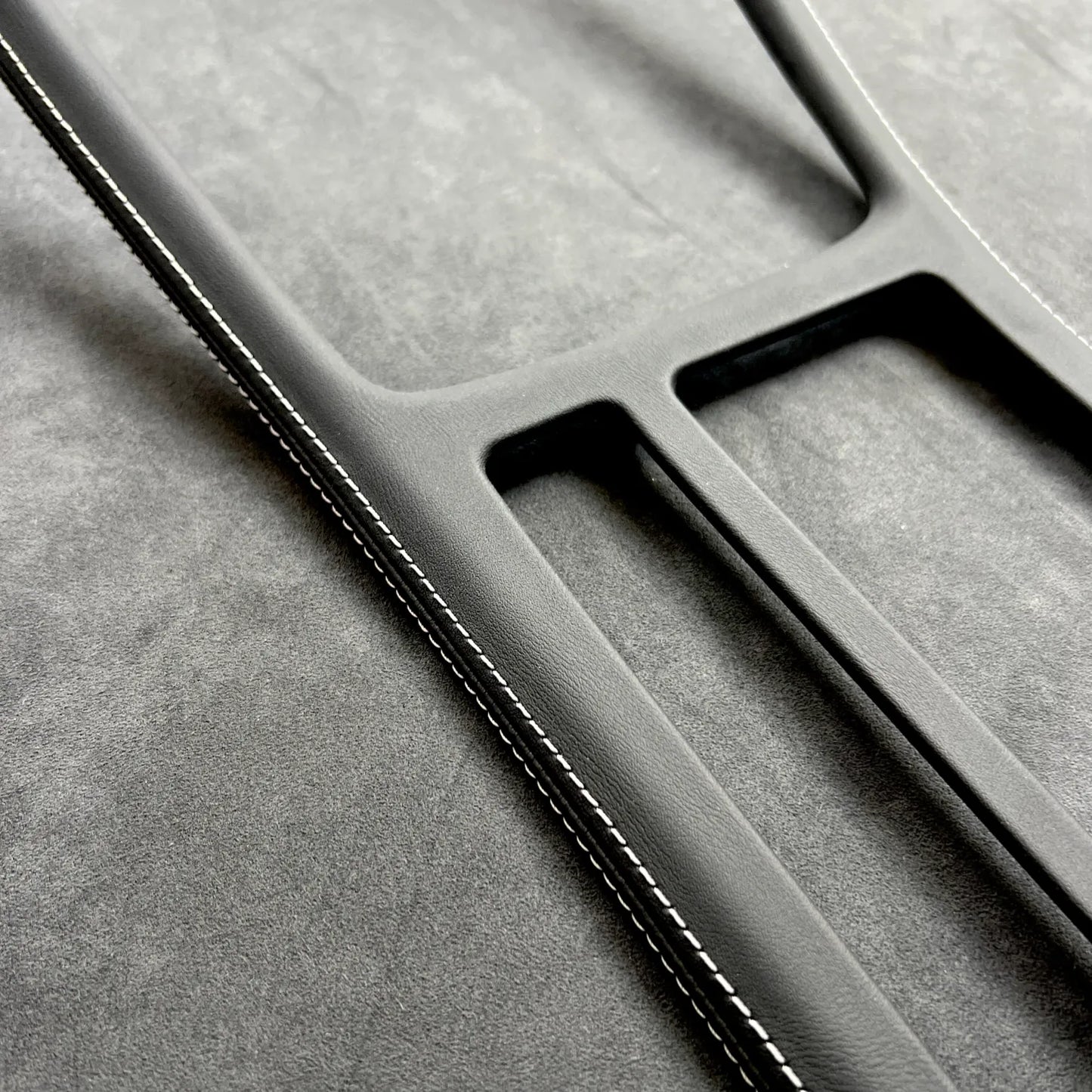 Close-up of Golf MK7 GTI gear shift panel cover in Alcantara with red stitching, protecting OEM plastic and enhancing interior.