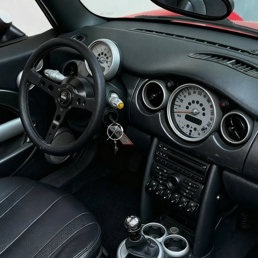 Installed view of MINI Cooper R53 steering wheel hub adaptor showing seamless fitment with aftermarket steering wheel and factory-style finish inside Gen 1 MINI interior.
