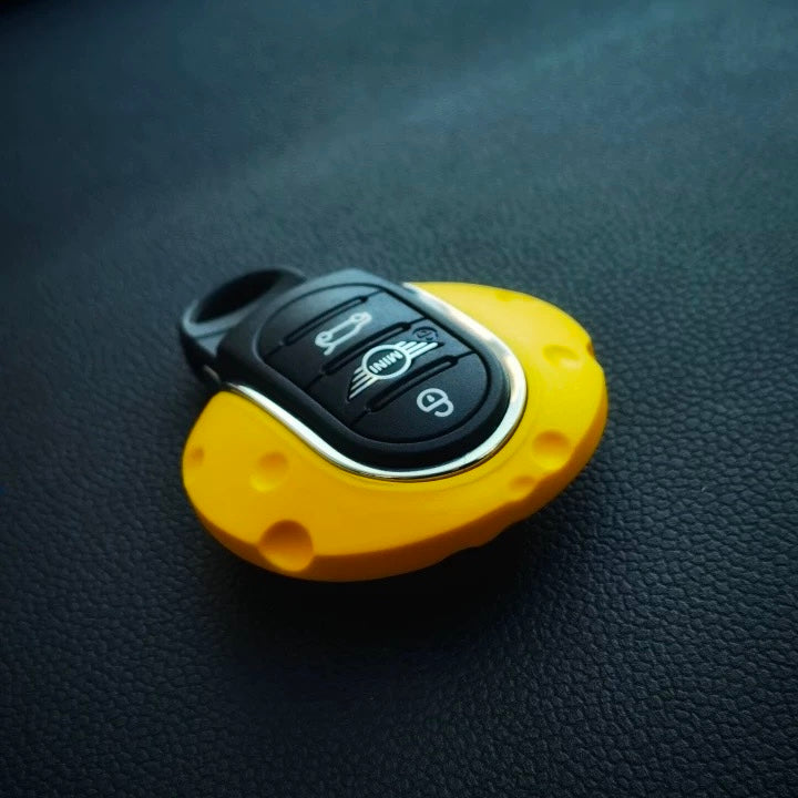 Angled view of the cheese-inspired key fob cover, demonstrating its unique aesthetic and compatibility with F-Series keys.
