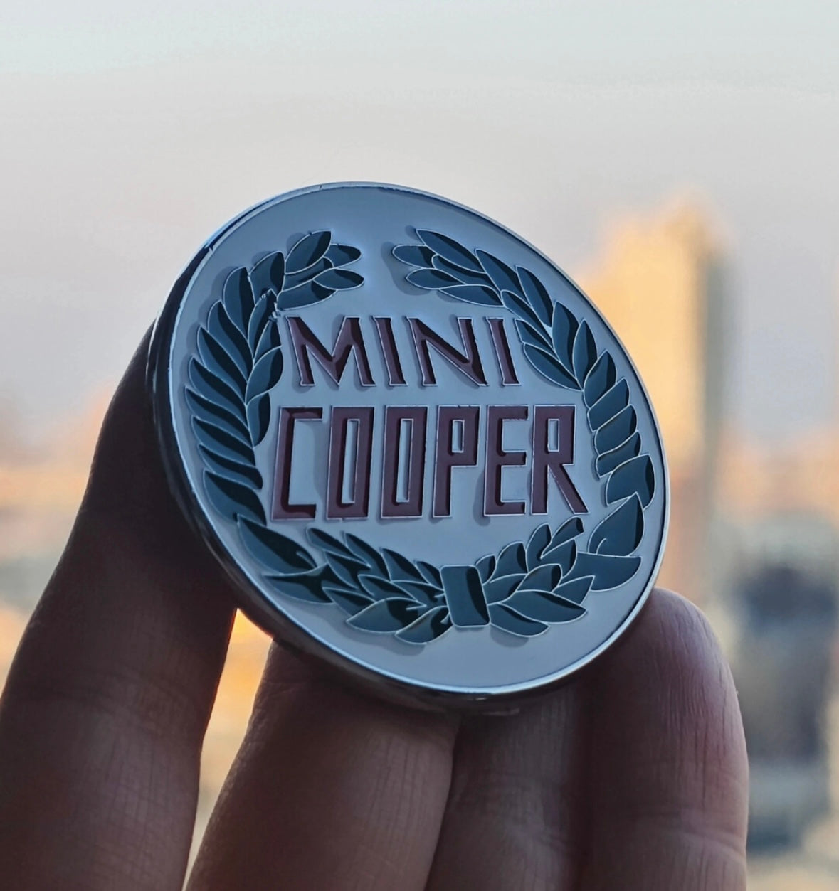 Side view of the MINI Cooper heritage enamel badge showcasing its durable metal construction and enamel finish.