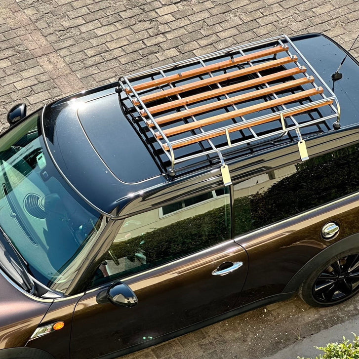 Chrome wood-slatted roof rack on MINI Clubman, rally aesthetic.