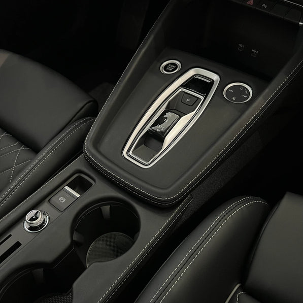 Audi A3 S3 RS3 8Y5 Facelift Unibody leather console cover with matching cupholder installed, angled view — piano black fix