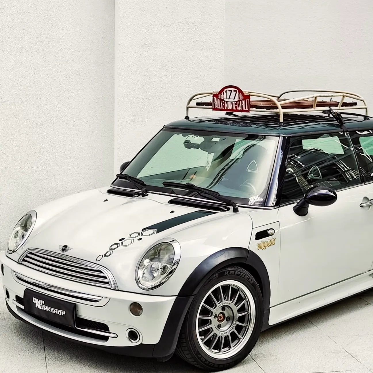 Detailed shot of handmade MINI roof rack with real wood slats and polished metal brackets.