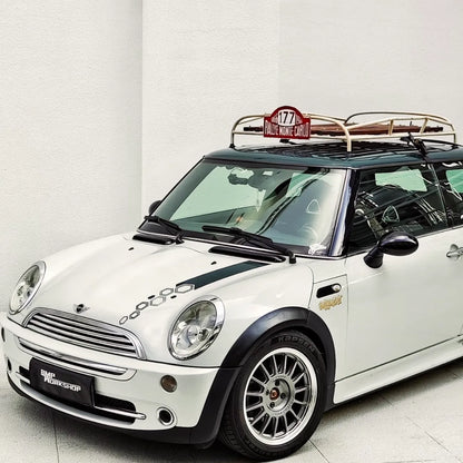 Detailed shot of handmade MINI roof rack with real wood slats and polished metal brackets.