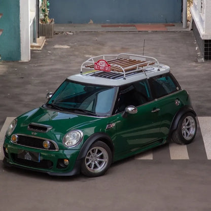 Close-up of Classic MINI roof rack showing real wood slats and polished stainless steel frame.