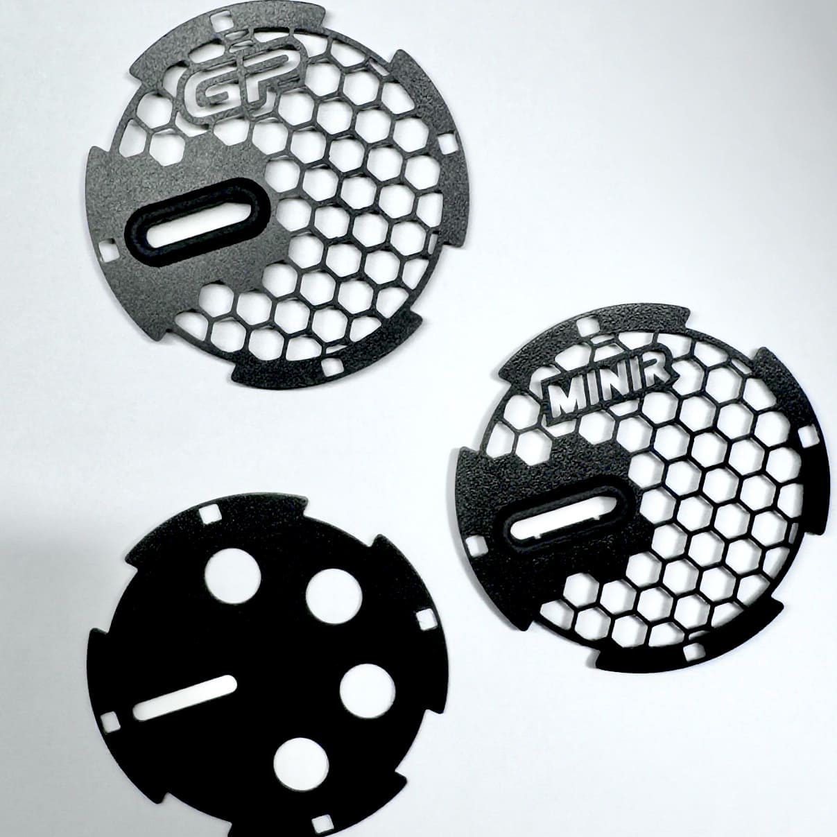 Side-by-side view of nylon and leather red RS-style handle pull straps for MINI Cooper R56.