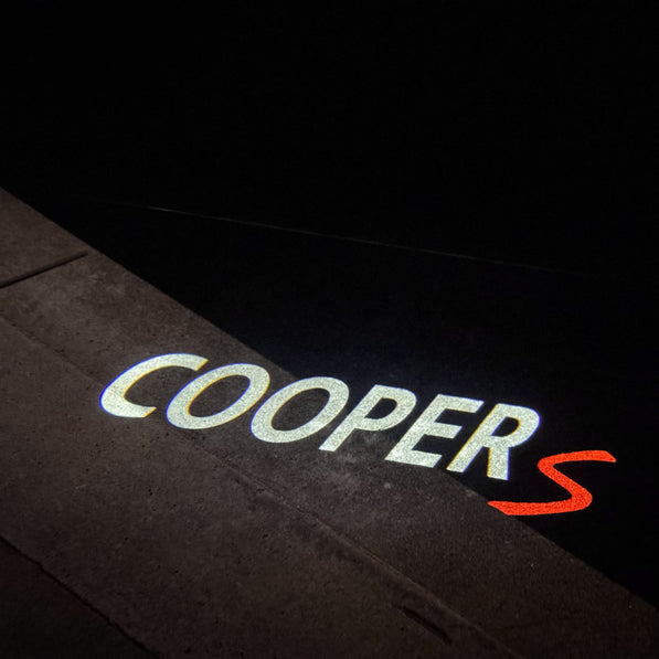 Cooper S puddle light glowing under open door of MINI F60 Countryman