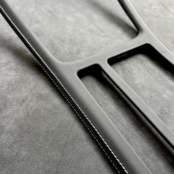 Close-up of Golf MK7 GTI gear shift panel cover in Alcantara with red stitching, protecting OEM plastic and enhancing interior.