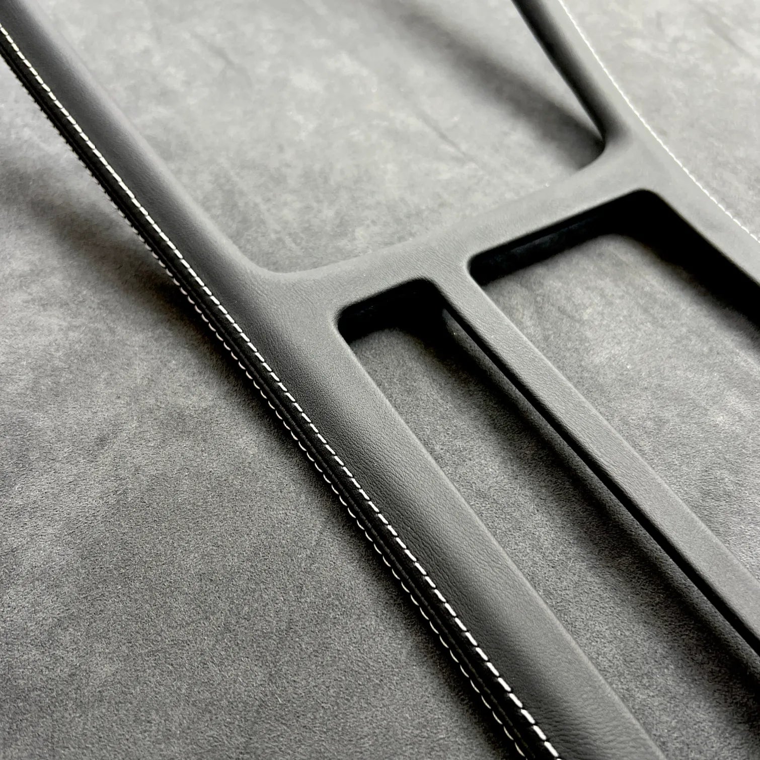 Close-up of Golf MK7 GTI gear shift panel cover in Alcantara with red stitching, protecting OEM plastic and enhancing interior.