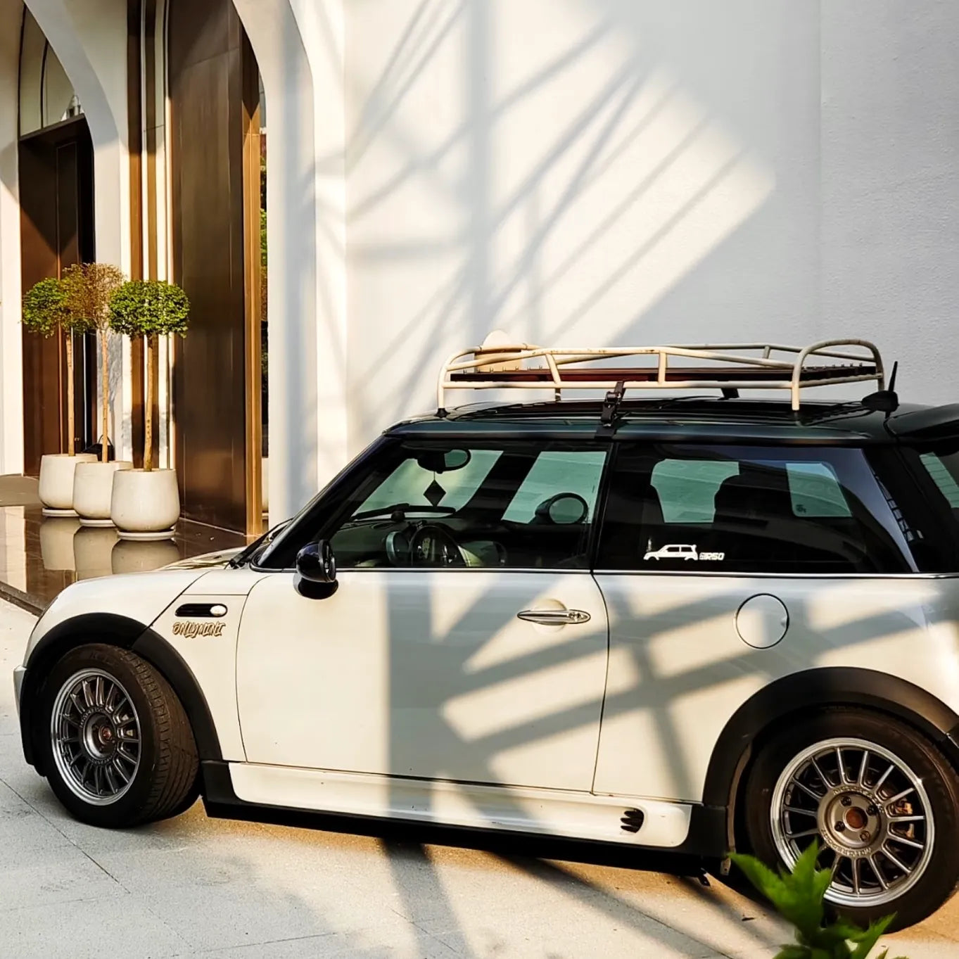 Top-down perspective of R55 Clubman with custom wood roof rack installed for vintage styling.