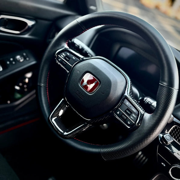 Gloss carbon fiber steering wheel trim overlay on Honda Civic Type R FL5, delivering a clean performance-inspired accent while maintaining OEM balance.