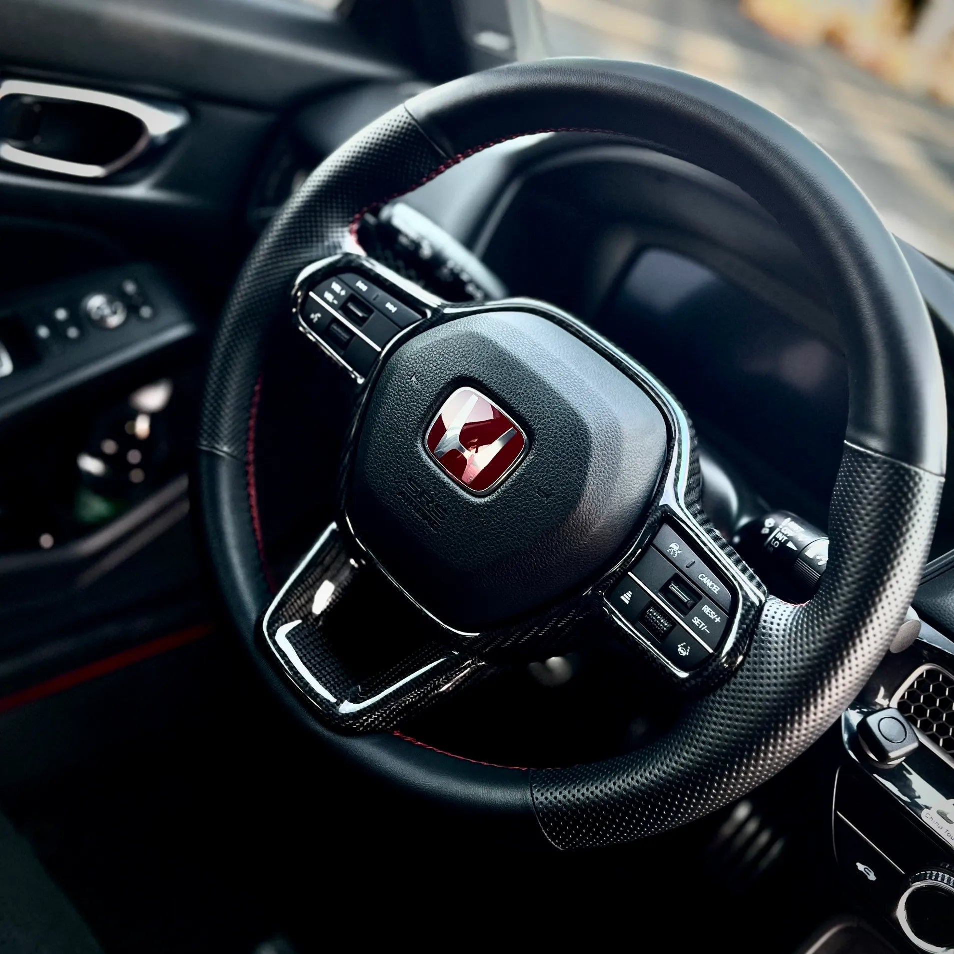 Gloss carbon fiber steering wheel trim overlay on Honda Civic Type R FL5, delivering a clean performance-inspired accent while maintaining OEM balance.