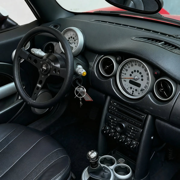 Installed view of MINI Cooper R53 steering wheel hub adaptor showing seamless fitment with aftermarket steering wheel and factory-style finish inside Gen 1 MINI interior.