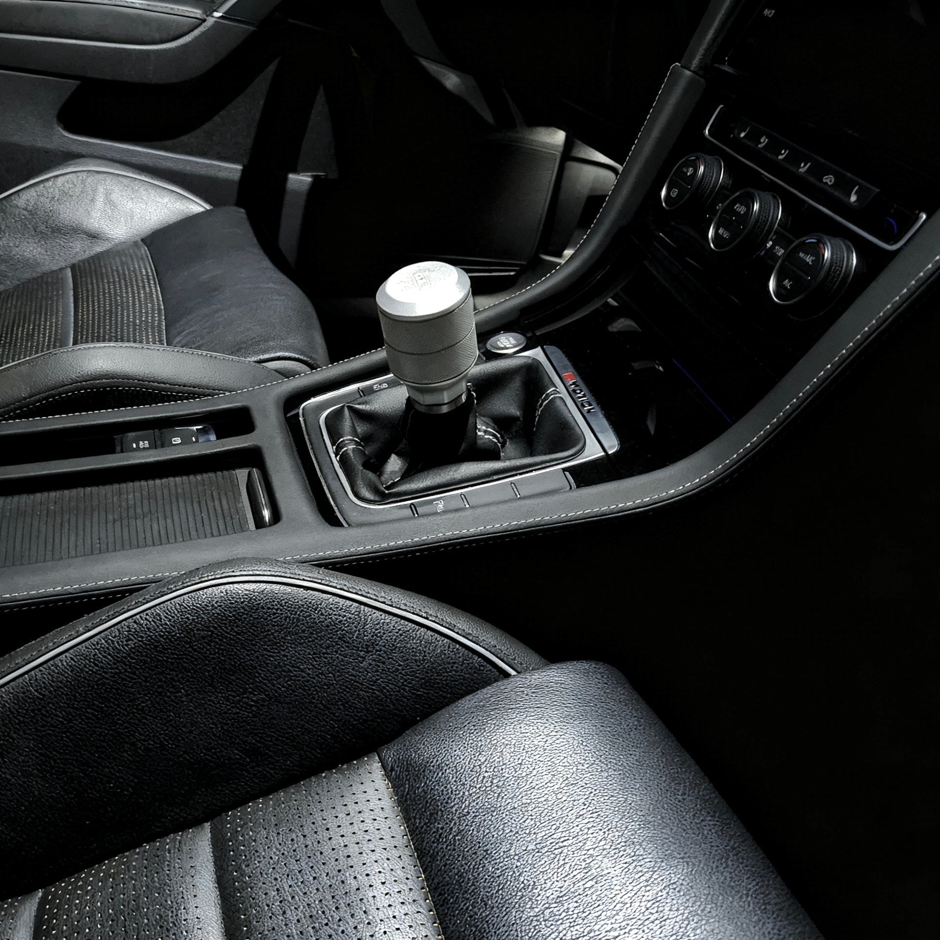 VW Golf R MK7 interior featuring installed Alcantara gear shift panel cover with seamless factory-style fit and luxury finish.
