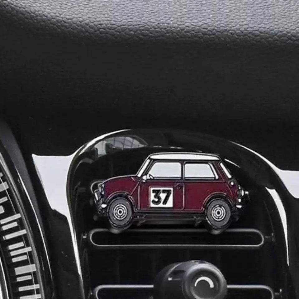 Burgundy air freshener installed in a MINI Cooper, adding a classic rally touch to the interior.