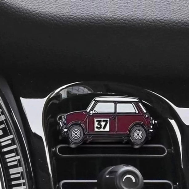 Burgundy air freshener installed in a MINI Cooper, adding a classic rally touch to the interior.