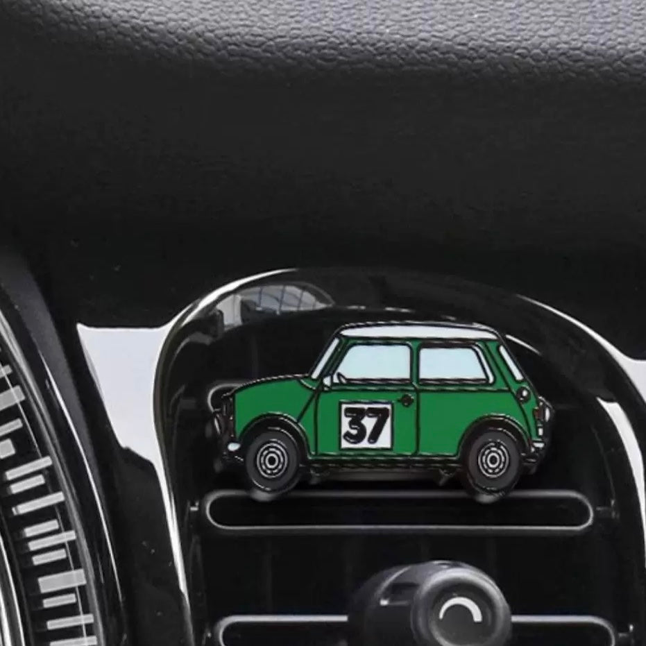Racing green air freshener installed in a MINI Cooper, blending sporty style with nostalgic design.