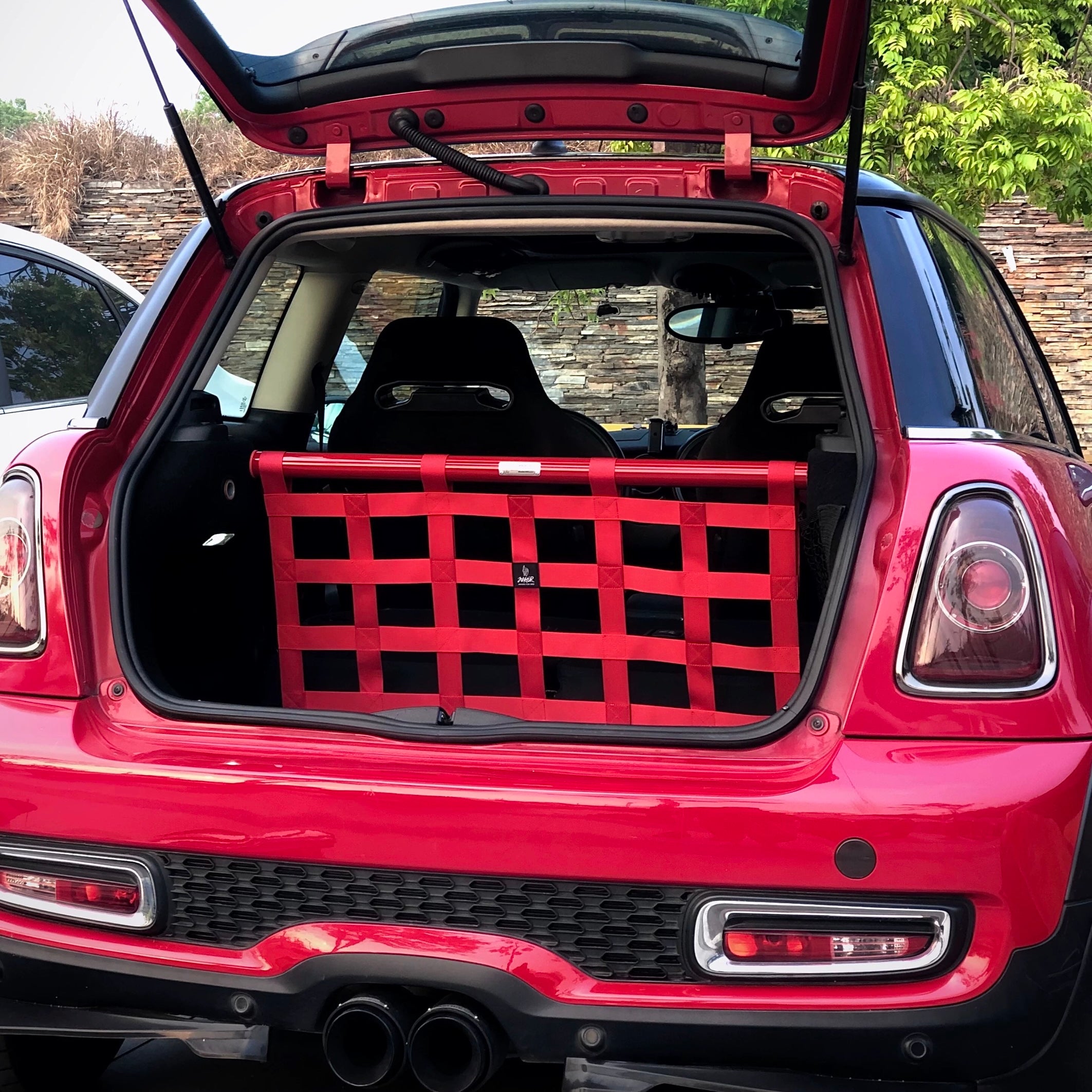 Rear view of the MINI Cooper cargo racing net installed, demonstrating its secure fit and smart storage capabilities.