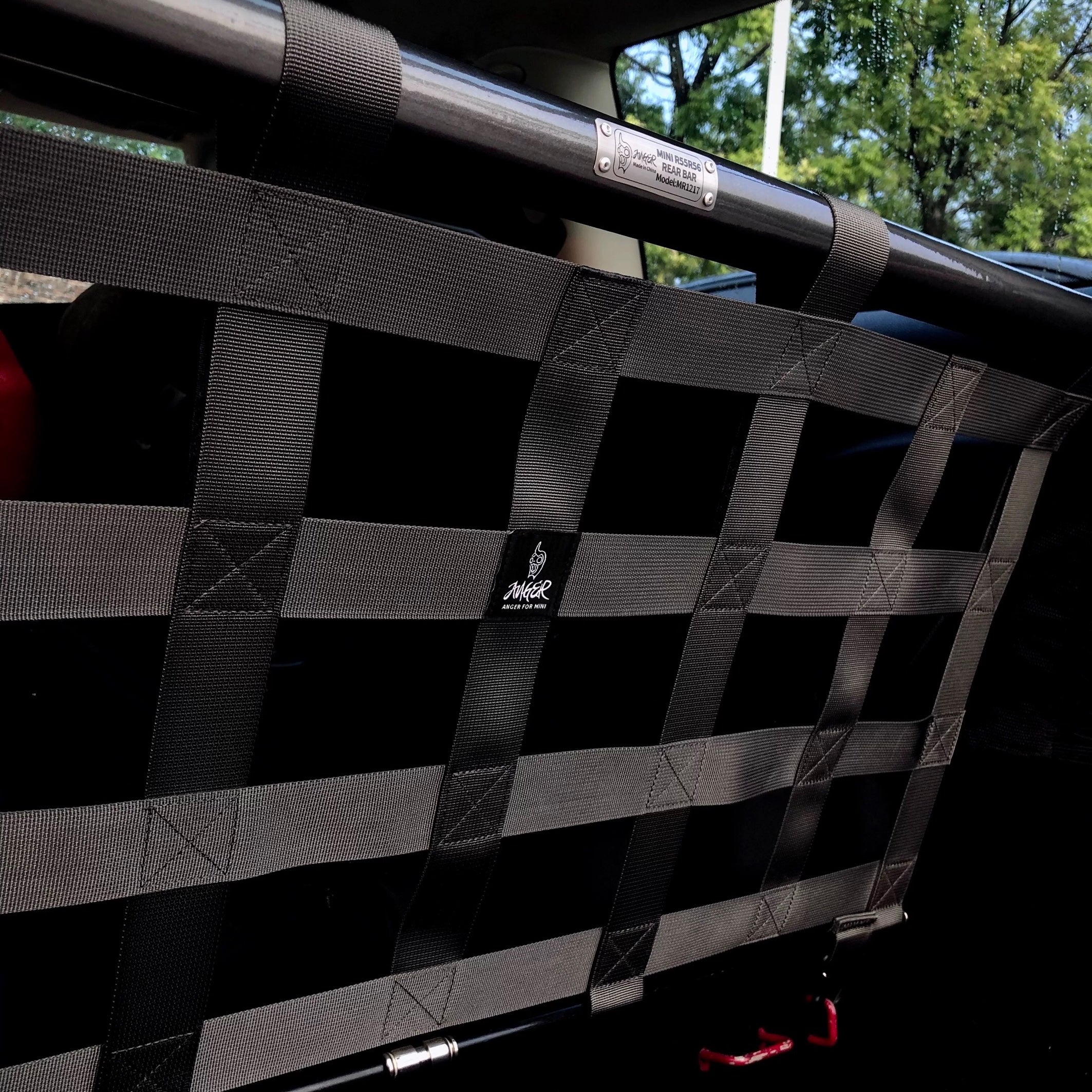 Side view of the gun metal cargo racing net installed in a MINI Cooper, highlighting its adjustable height and sleek design.