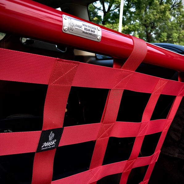 Side view of the red cargo racing net installed in a MINI Cooper, showcasing its sporty and functional appeal.