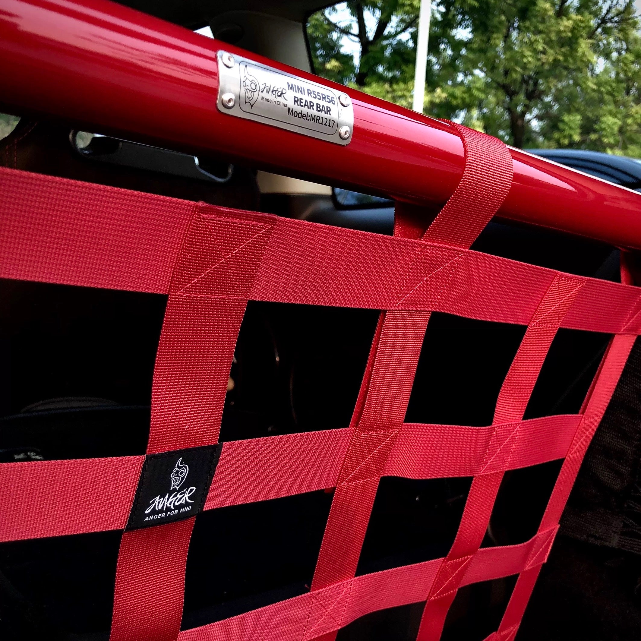 Side view of the red cargo racing net installed in a MINI Cooper, showcasing its sporty and functional appeal.
