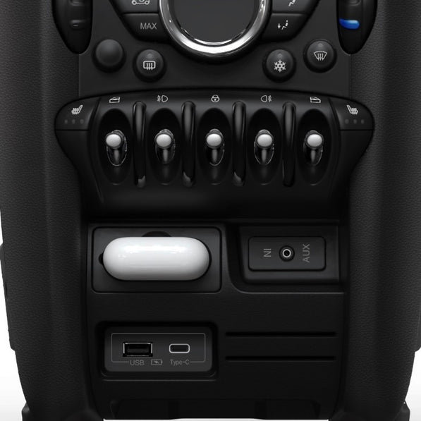 Front view of the MINI Cooper charging compartment, showcasing its sleek design and AirPods slot.