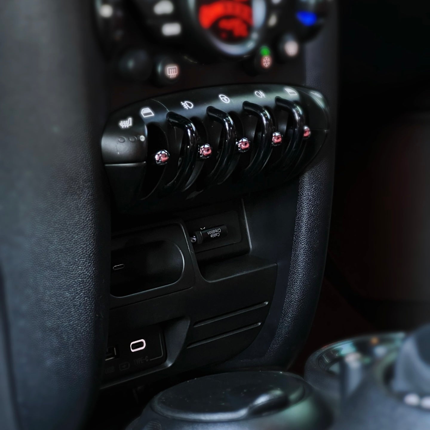 Detailed view of the USB and Type-C ports in the MINI Cooper charging compartment, perfect for modern devices.