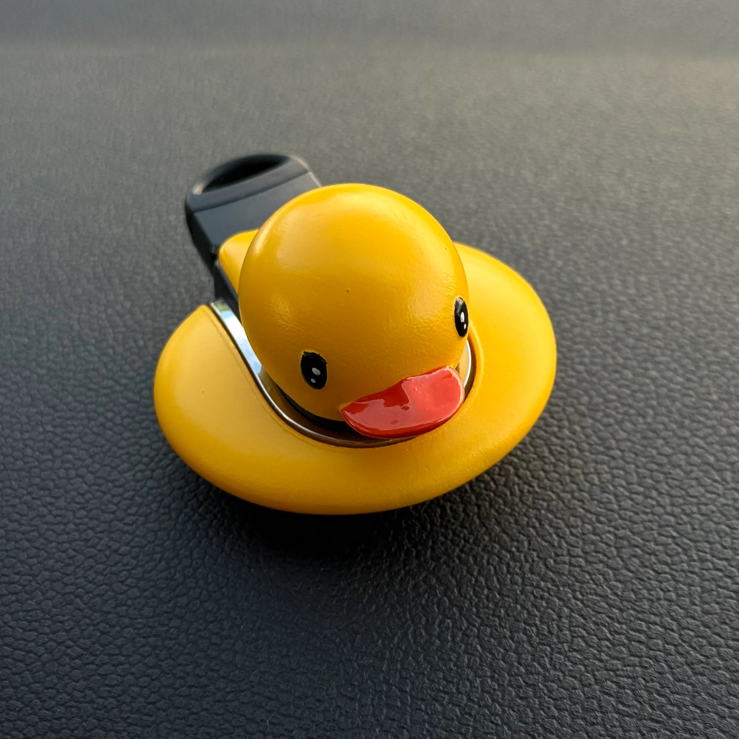Handmade MINI Cooper F-Series keyfob cover with yellow duck design shown in hand, fun and stylish aftermarket accessory.