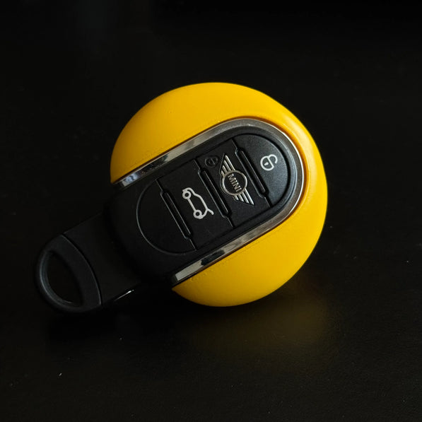 Close-up front view of yellow duck MINI Cooper keyfob cover showing handmade detail and glossy finish, fits F54–F60 models.