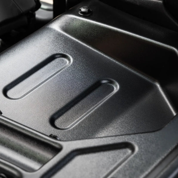 MINI Cooper R56 rear seat delete kit in OEM grain, along side compartments viewed from the rear hatch