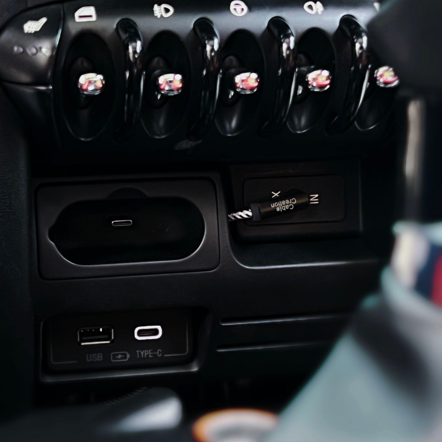 AirPods charging compartment installed in a MINI Cooper R56 dashboard, showcasing its seamless fit and modern design.