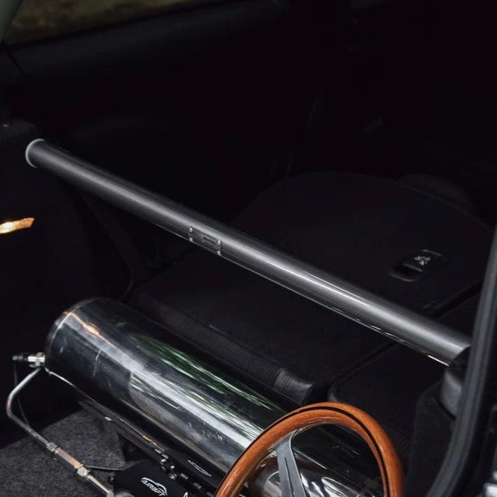 Carbon steel rear strut brace installed in a MINI Cooper R56, showcasing its sleek and streamlined design.