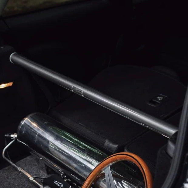 Carbon steel rear strut brace installed in a MINI Cooper R56, showcasing its sleek and streamlined design.