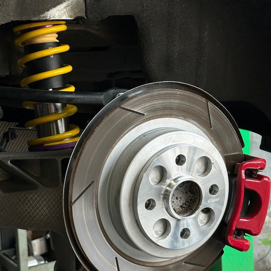 10mm wheel spacer placed on a MINI Cooper brake disc, demonstrating proper fitment and installation.