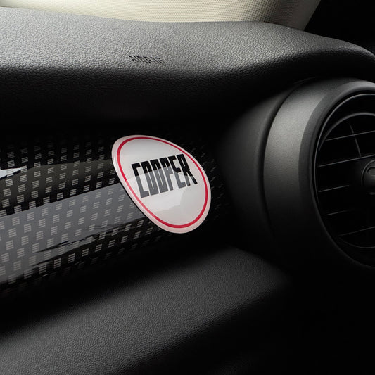 Close-up of the MINI Cooper 'COOPER' gel sticker, showcasing its domed finish and retro design.