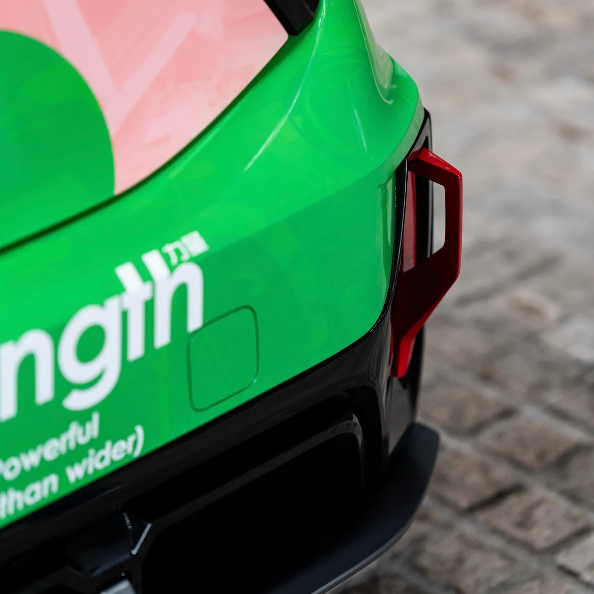 Rear angle of MINI J01 Cooper Electric with dry carbon roof spoiler and skirts