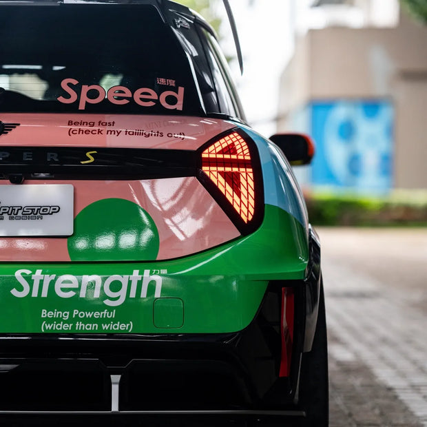 Rear view of MINI JCW J01 Electric with dry carbon spoiler, bumper decor, and diffuser