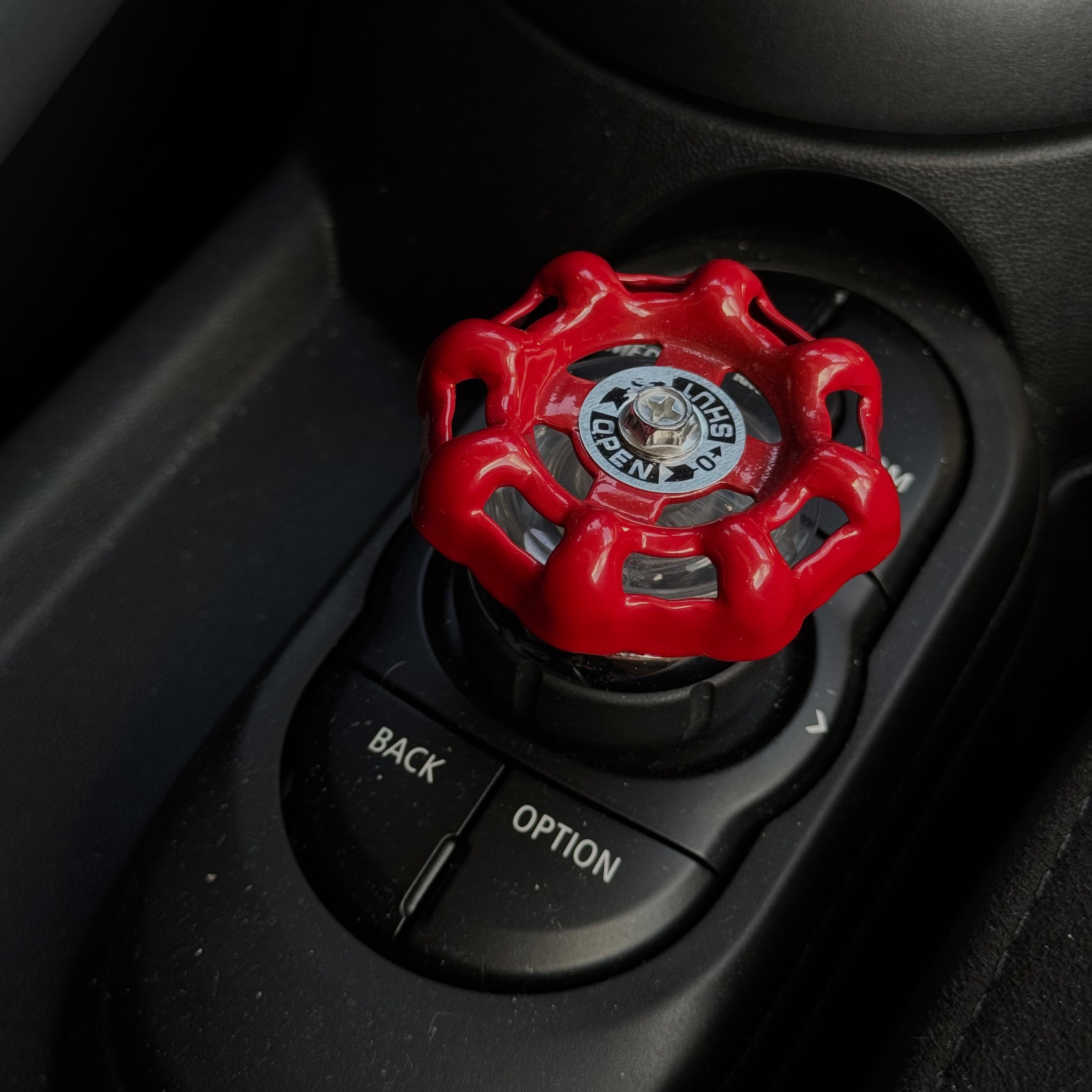 Side view of the MINI iDrive button decoration, highlighting its lightweight aluminum construction and precision fit.