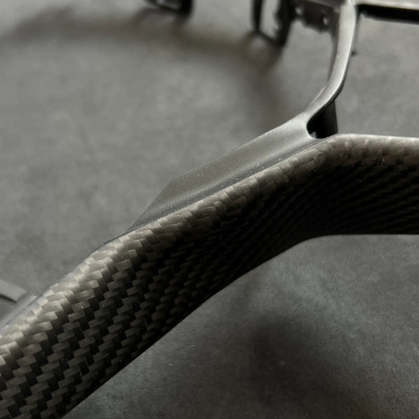 Direct replacement carbon fiber steering wheel trim for the VW Golf MK8 GTI, providing a motorsport-inspired visual upgrade with no modifications required.