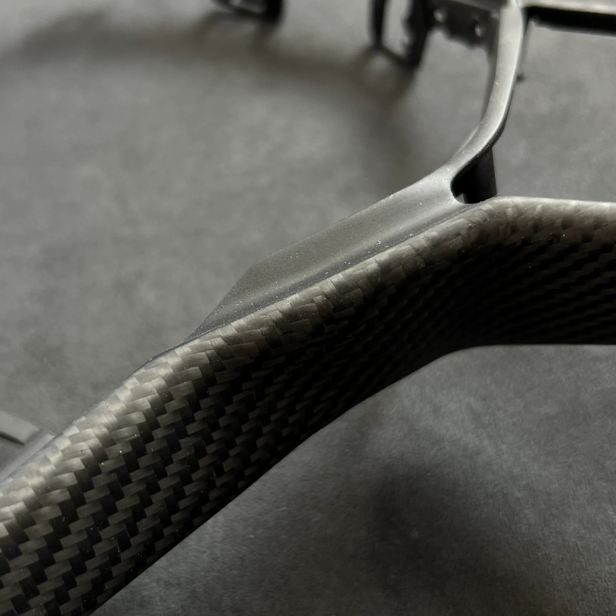 Direct replacement carbon fiber steering wheel trim for the VW Golf MK8 GTI, providing a motorsport-inspired visual upgrade with no modifications required.