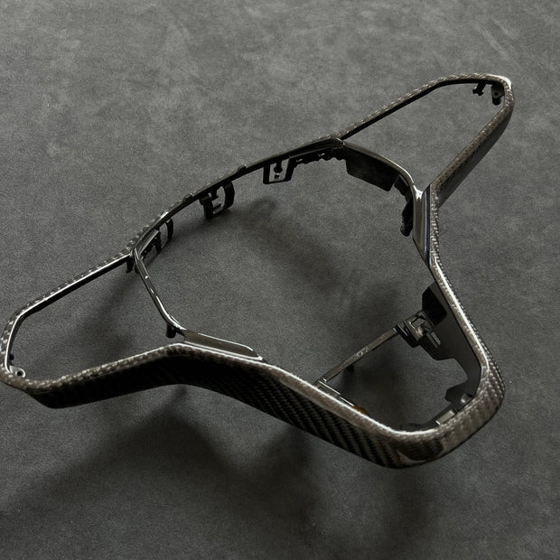 Premium craftsmanship carbon fiber replacement trim for VW Golf MK8 GTI and R steering wheels, offering durable construction and a high-end motorsport feel.