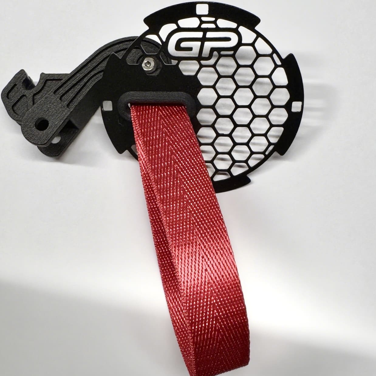 Nylon red RS-style handle pull strap on the driver side door of MINI Cooper R55.