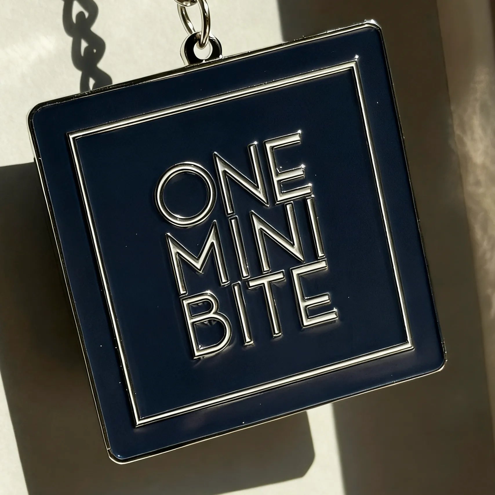 ONEMINIBITE square keyring with size comparison showing 5 cm (1.97 inch) dimensions