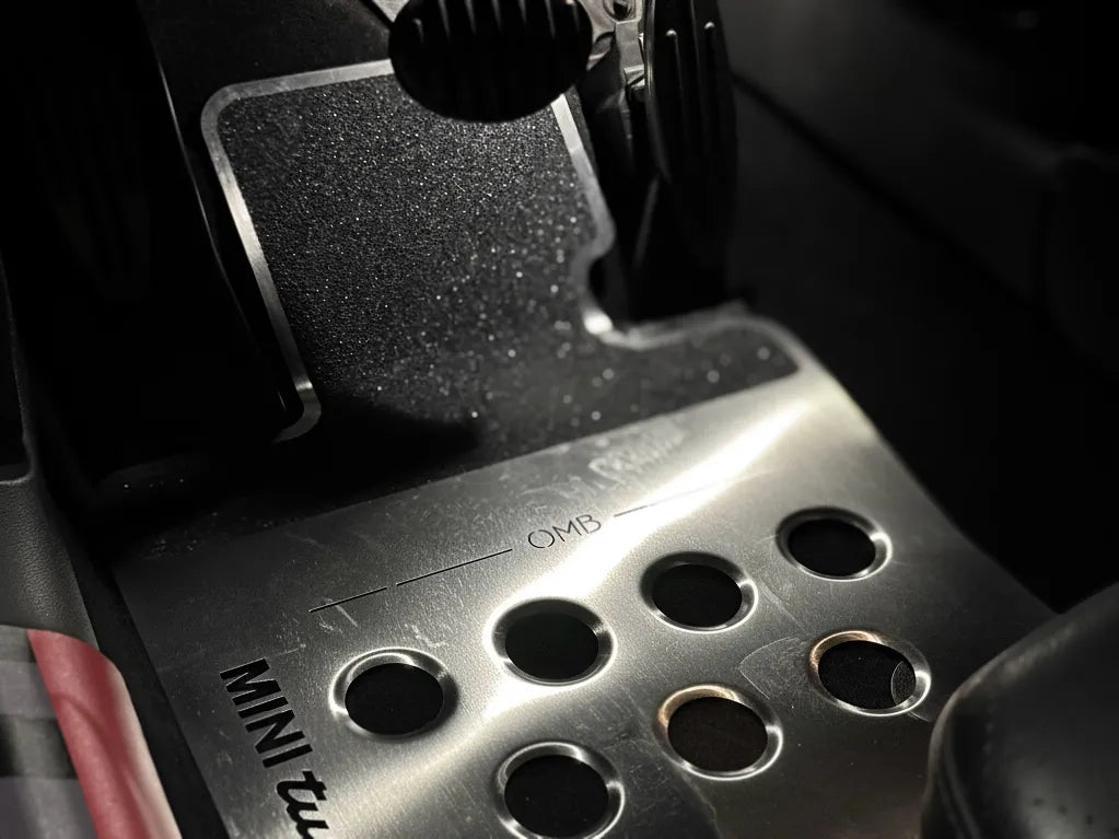 Wide-angle shot of MINI Cooper F56 GP3 interior showing OneMiniBite custom track mats, dashboard accents, and racing seat details.