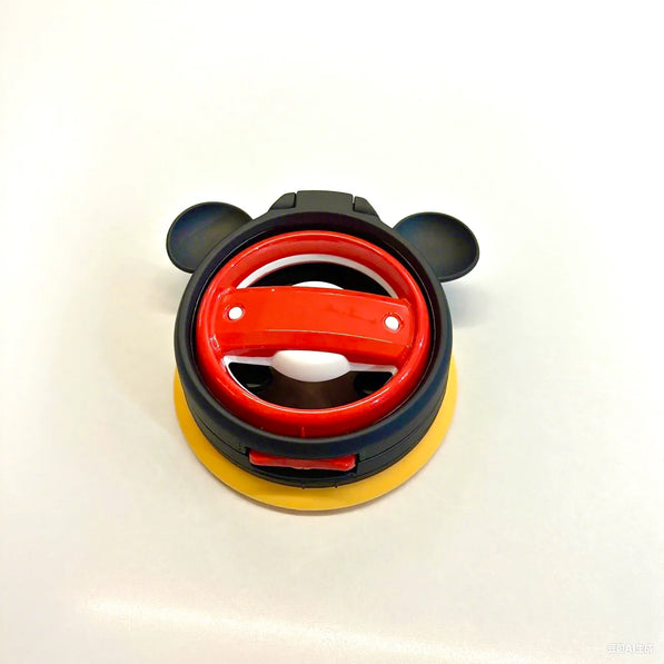 Playful mouse icon cup holder holding small items in Mini Cooper F55