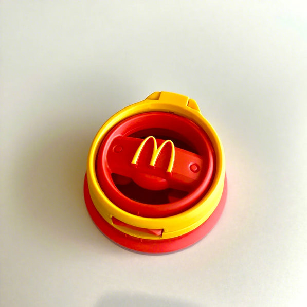 Red arch style cup holder attached to passenger side of Mini Cooper F55