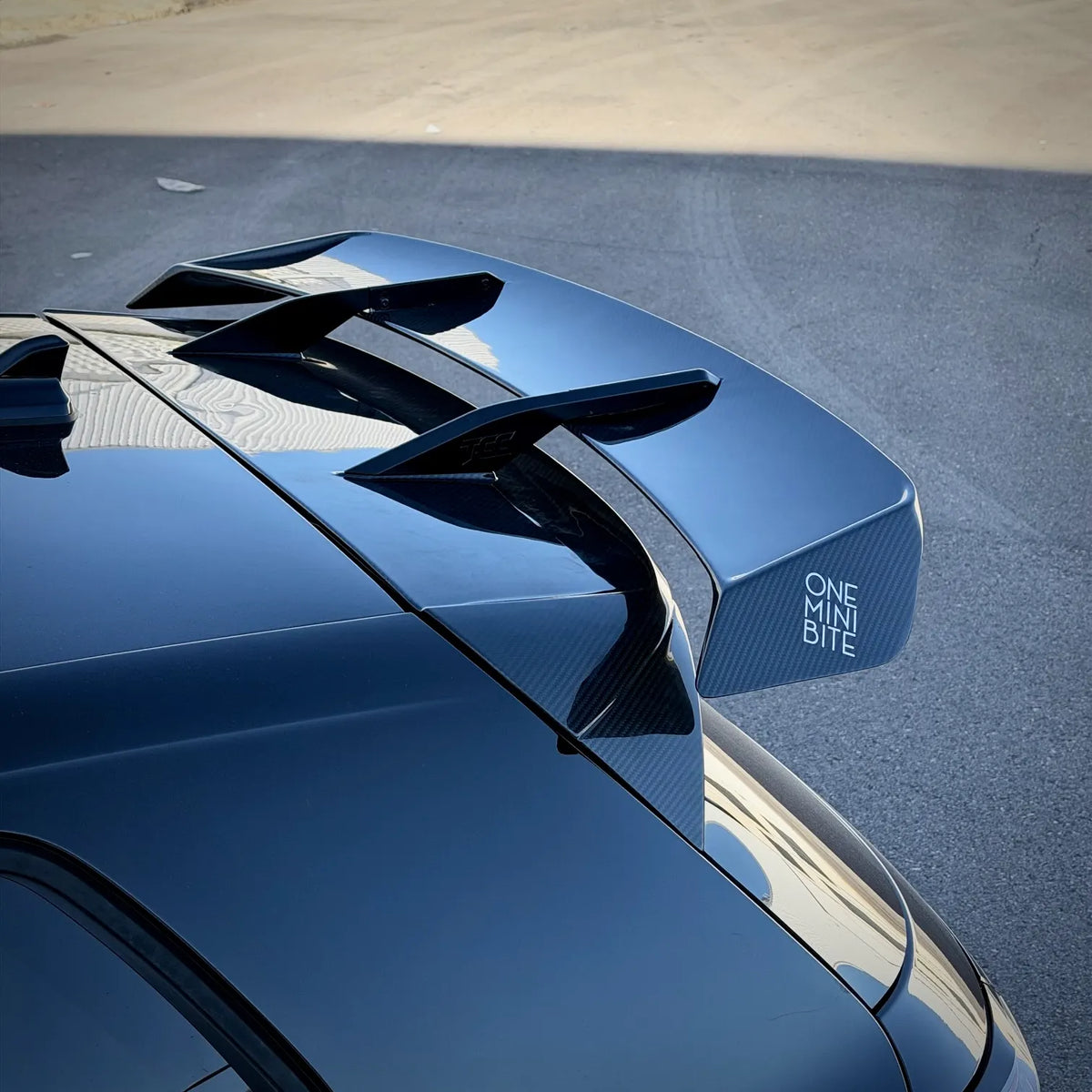 VW Golf MK8.5 R swan neck GT adjustable rear spoiler on a black Golf R