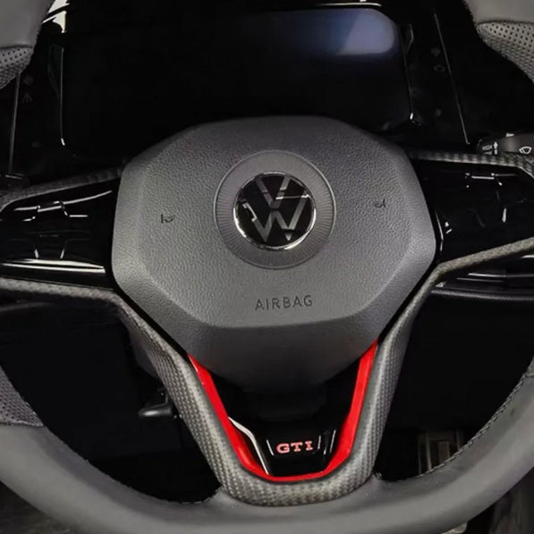 VW Golf MK8 steering wheel with carbon fiber trim installed, direct OEM replacement, compatible with left-hand and right-hand drive vehicles.
