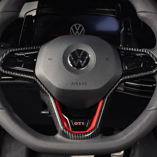 Close-up of VW Golf MK8 GTI and R carbon fiber steering wheel trim in gloss finish, showing high-quality weave and perfect OEM fit.